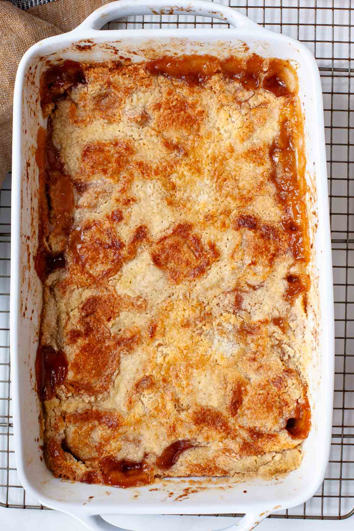 baked cake mix peach cobbler on wire rack